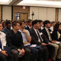 Students listen to speakers at the ceremony
